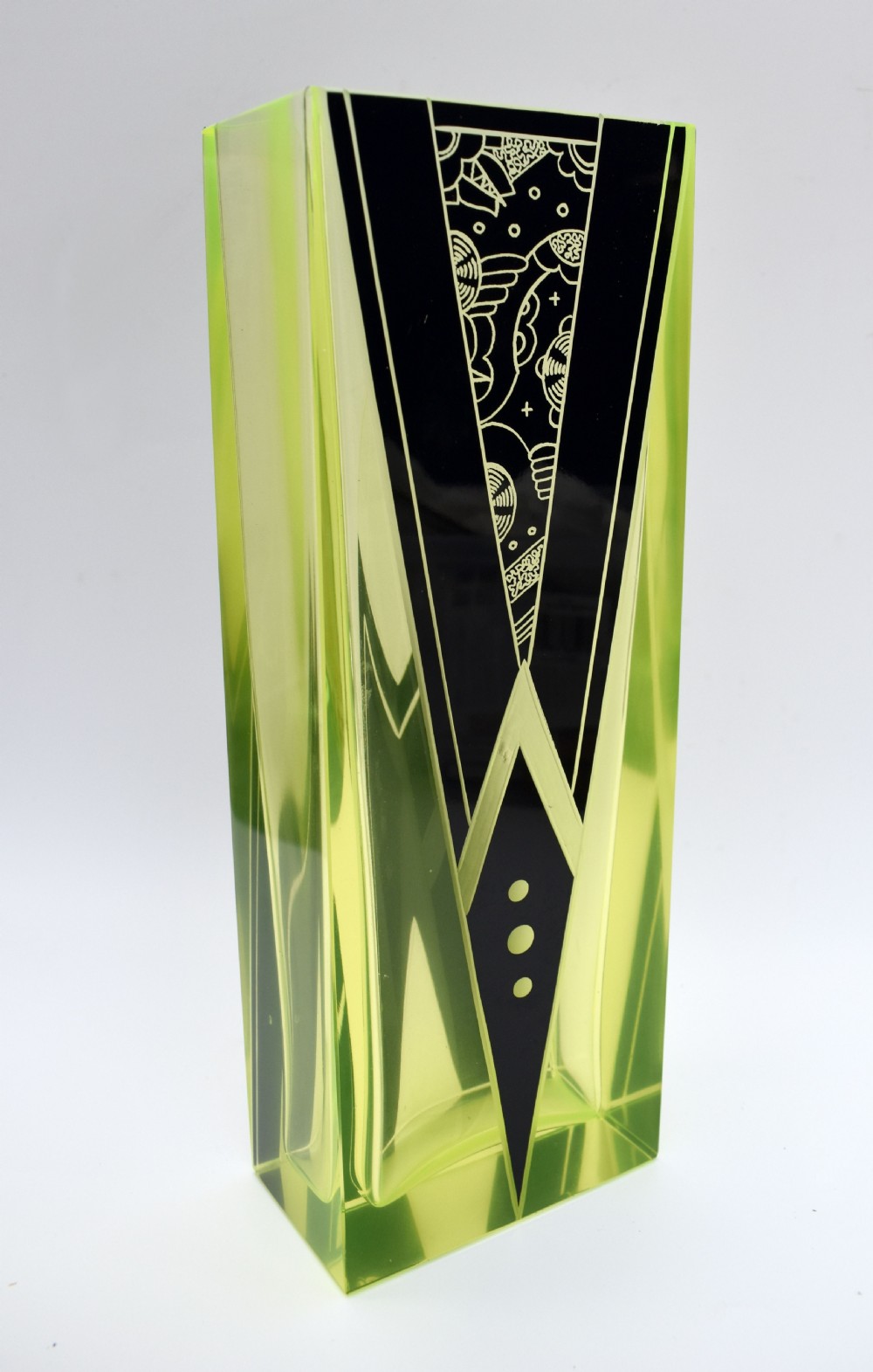 A tall rectangular yellow-green glass vase featuring black geometric Art Deco enamel patterns. View VII