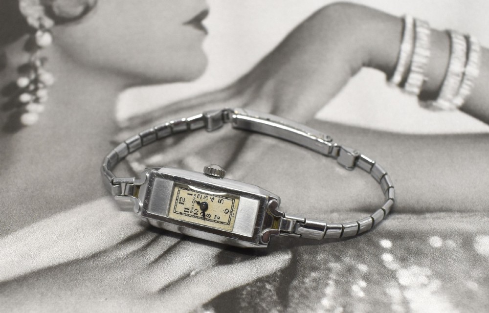 An Art Deco Bulova ladies bracelet watch from 1935 featuring a narrow rectangular silver-coloured case with geometric lugs and an articulated chain strap. View IV