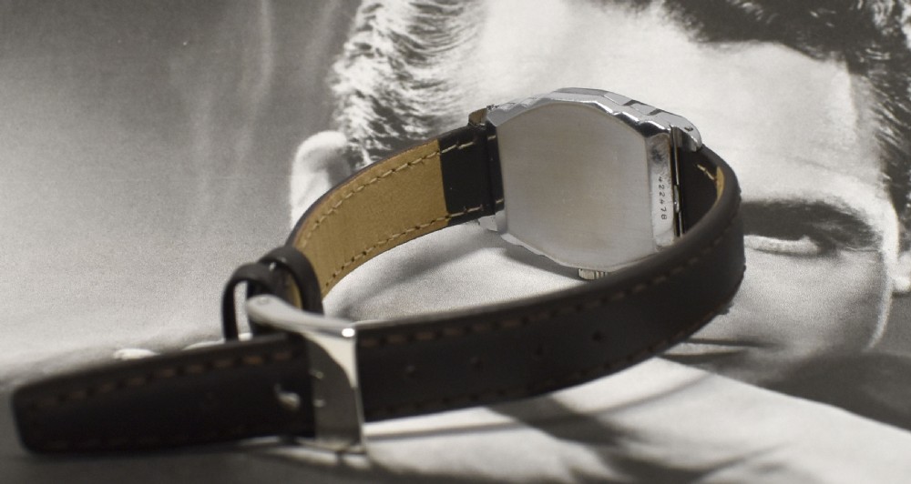 An Art Deco Bulova gentlemans wristwatch featuring a rectangular white gold fill case, off-white dial with Arabic numerals, sub-seconds dial, and a dark brown leather strap. View IV