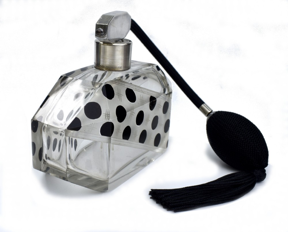 An Art Deco faceted clear glass perfume atomizer featuring black enamel polka dots, crosshatch etchings, a silver-toned metal mount, and a black fabric squeeze bulb with a tassel. View IV