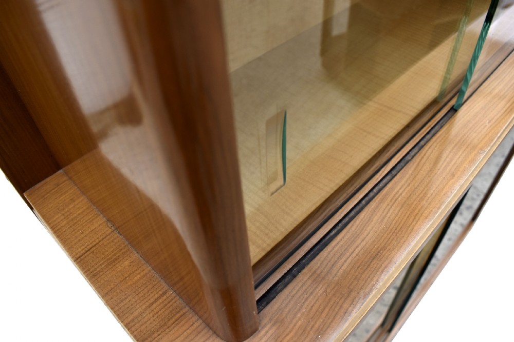 A two-tier Art Deco glazed bookcase constructed from contrasting light sycamore and dark walnut veneers with sliding glass doors. View VII