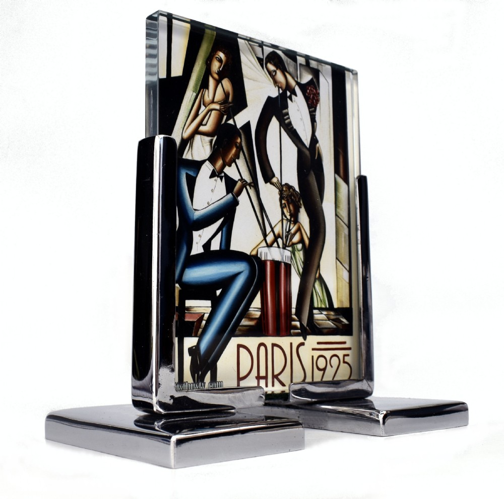 An Art Deco chrome and glass free-standing picture frame featuring a stepped metal base holding a black and white portrait photo. View III