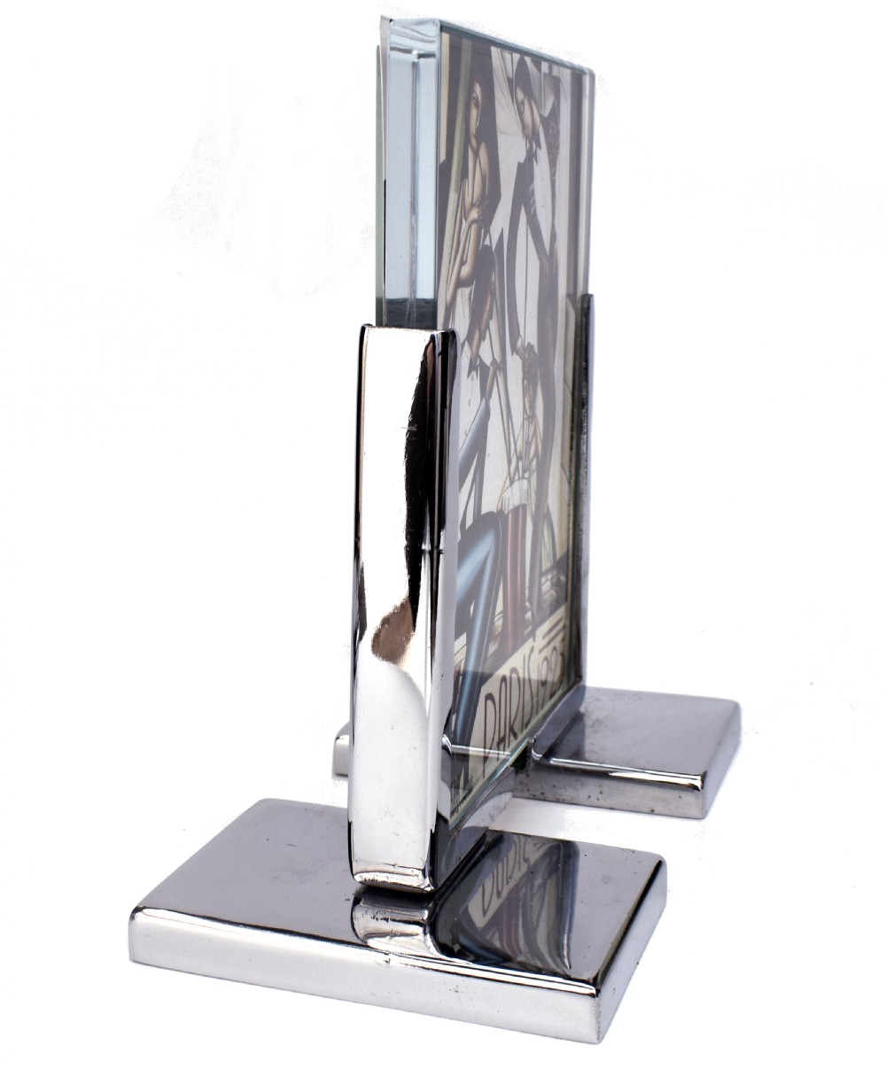 An Art Deco chrome and glass free-standing picture frame featuring a stepped metal base holding a black and white portrait photo. View IV