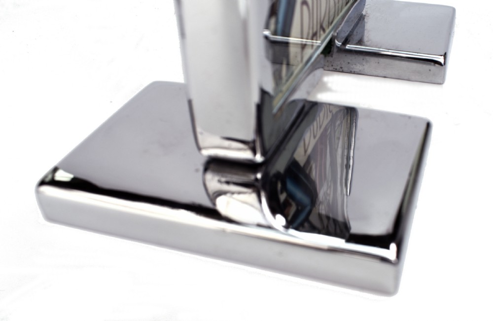 An Art Deco chrome and glass free-standing picture frame featuring a stepped metal base holding a black and white portrait photo. View V