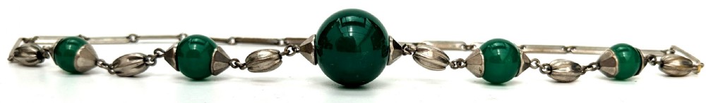 An Art Deco necklace featuring deep green glass spherical beads fitted with fluted metal caps and connected by elongated metal bar links. View IV