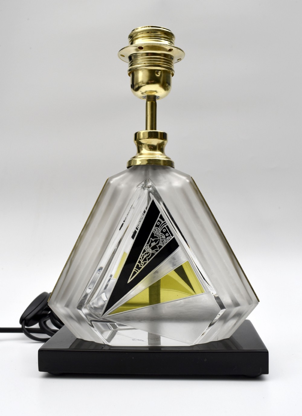 An Art Deco table lamp featuring a geometric cut and enamelled glass base with yellow accents and a printed fan pattern fabric shade. View II