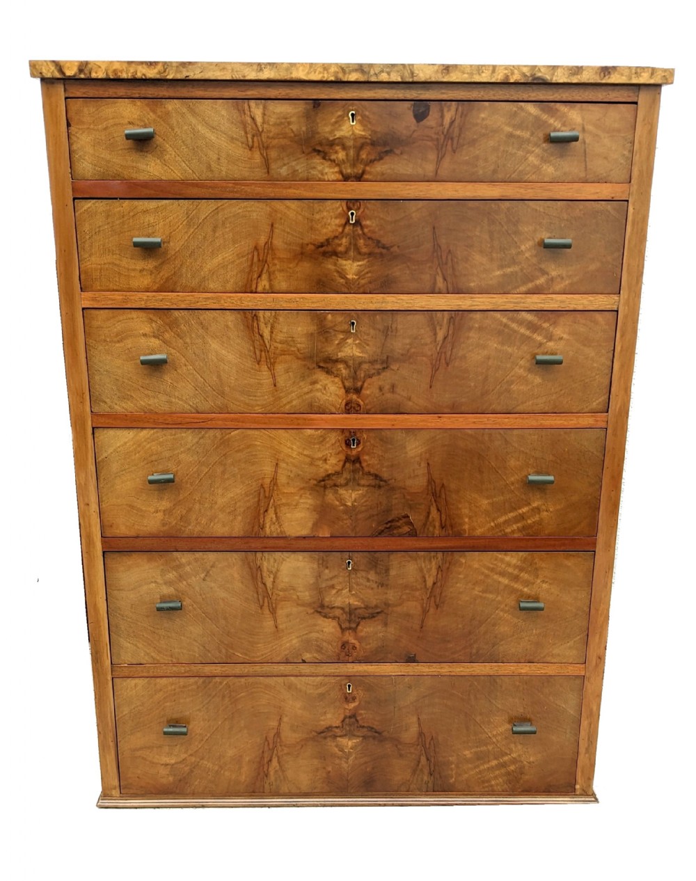 A tall Art Deco walnut chest featuring six drawers with book-matched wood grain veneer fronts and small cylindrical handles.