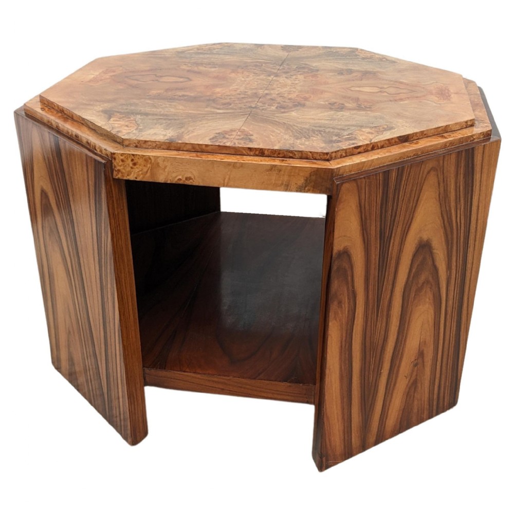 An octagonal Art Deco occasional table crafted from rich burr walnut with a lower shelf and broad panel legs.