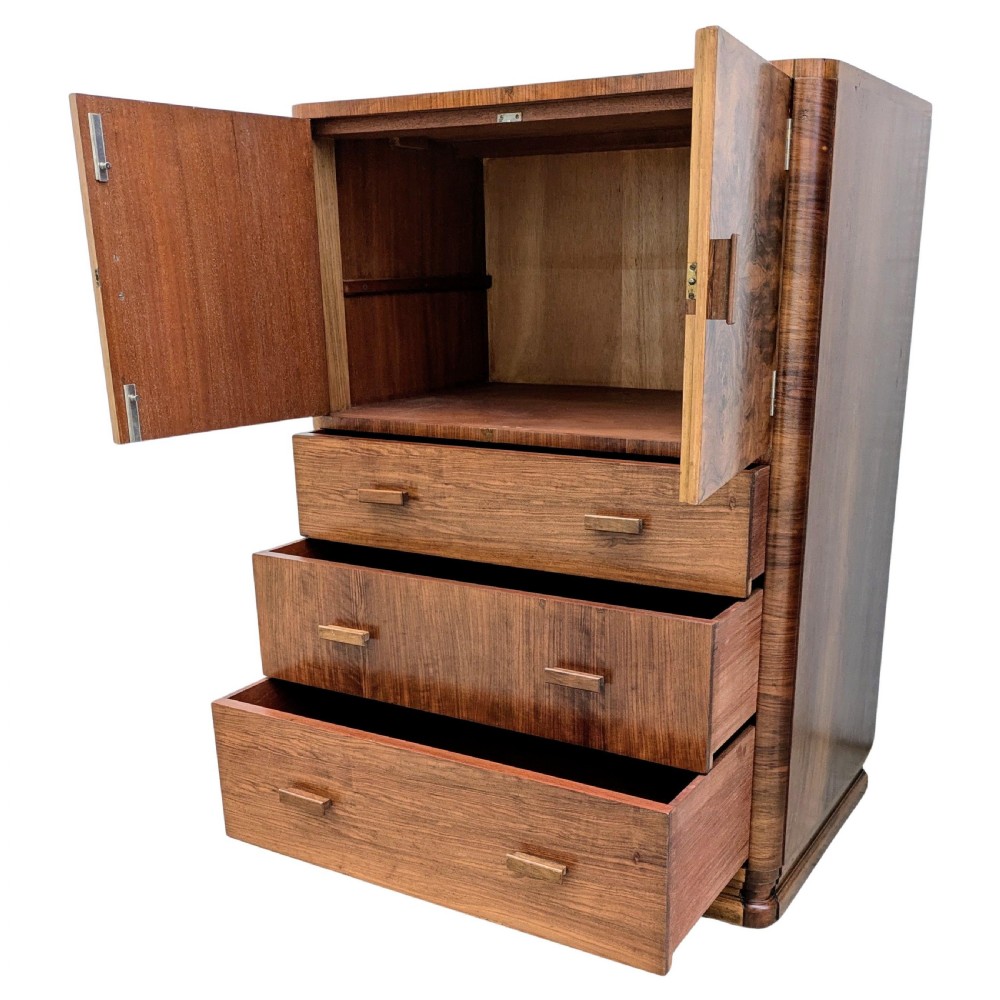 An English Art Deco tallboy crafted from figured burr walnut, featuring a top two-door cupboard above three full-width drawers with matching handles. View X