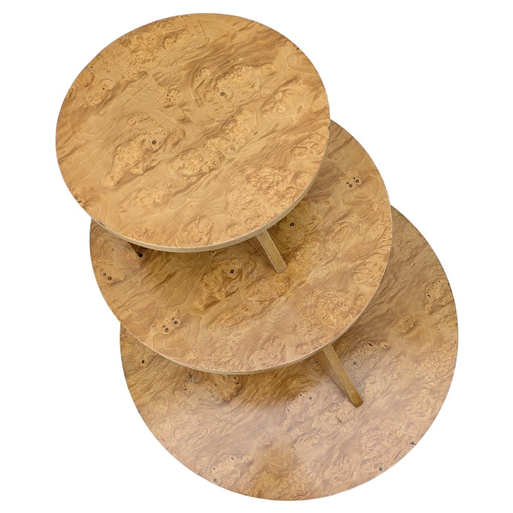 A matching pair of British Art Deco three-tiered modernist occasional tables featuring figured light brown wood veneer and architectural angular supports. View V