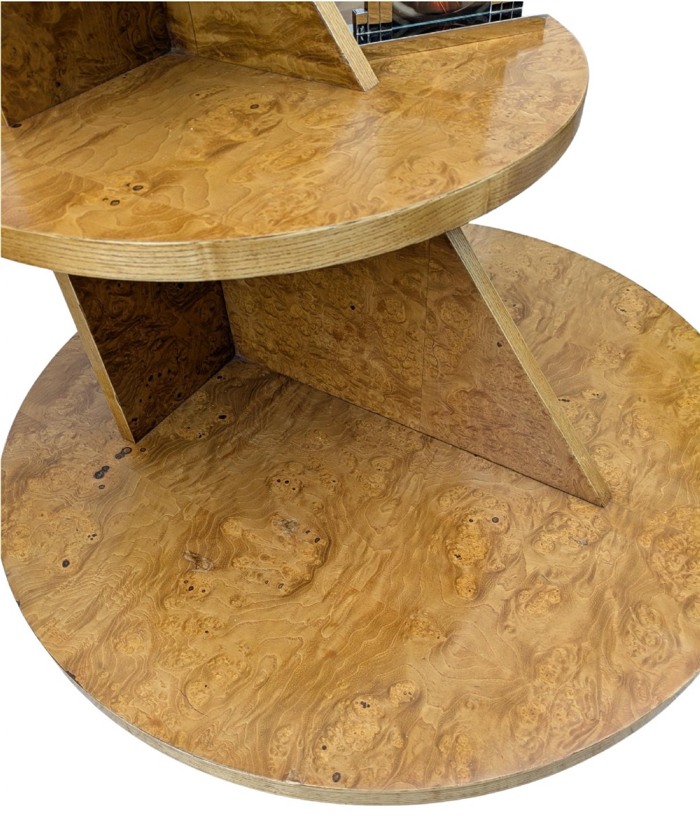 A matching pair of British Art Deco three-tiered modernist occasional tables featuring figured light brown wood veneer and architectural angular supports. View VII