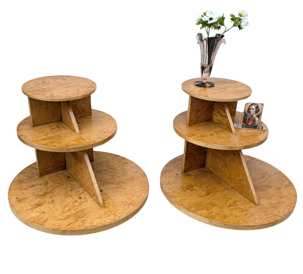 A matching pair of British Art Deco three-tiered modernist occasional tables featuring figured light brown wood veneer and architectural angular supports. View XII