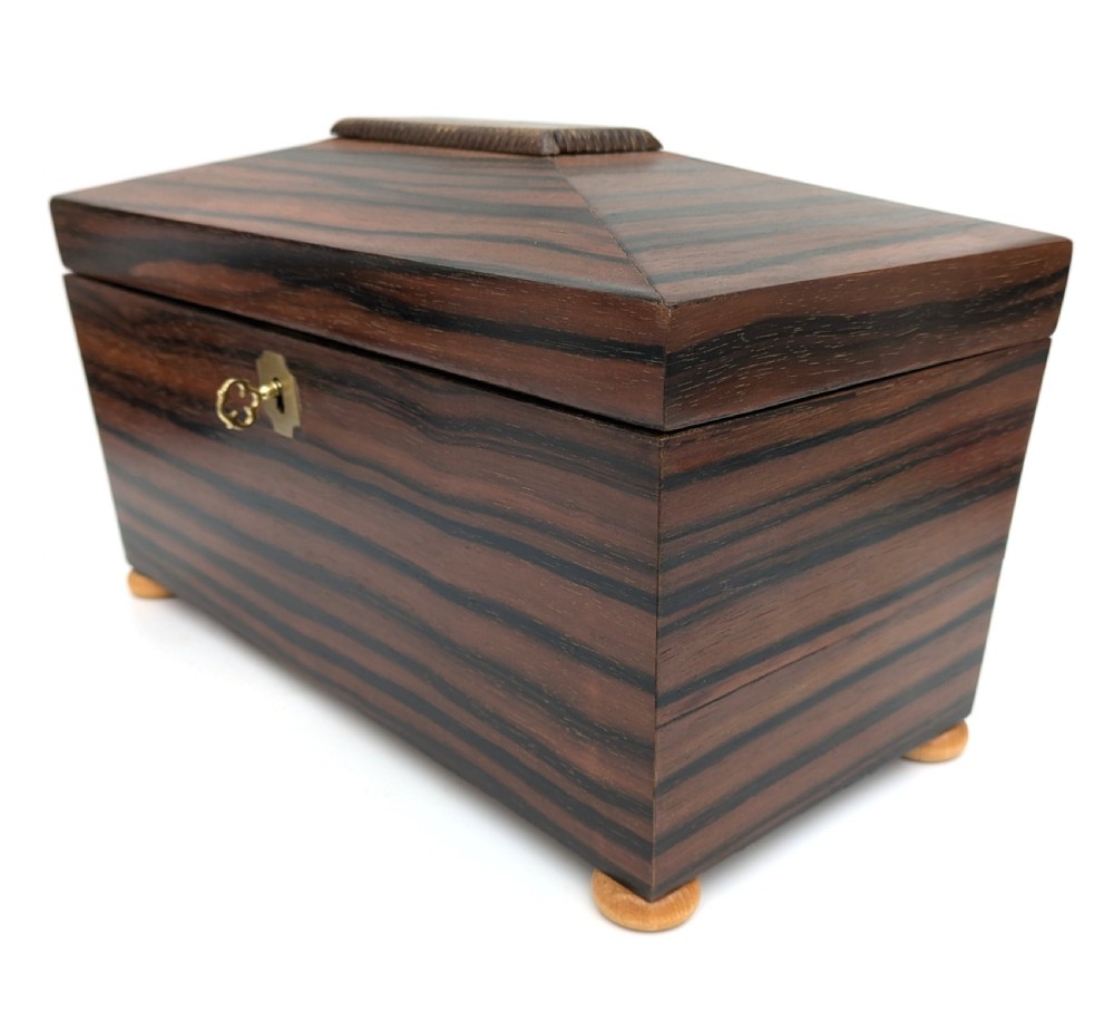An open Art Deco dark wood tea caddy featuring a light wood sunburst inlay pattern on its internal lid. View VII