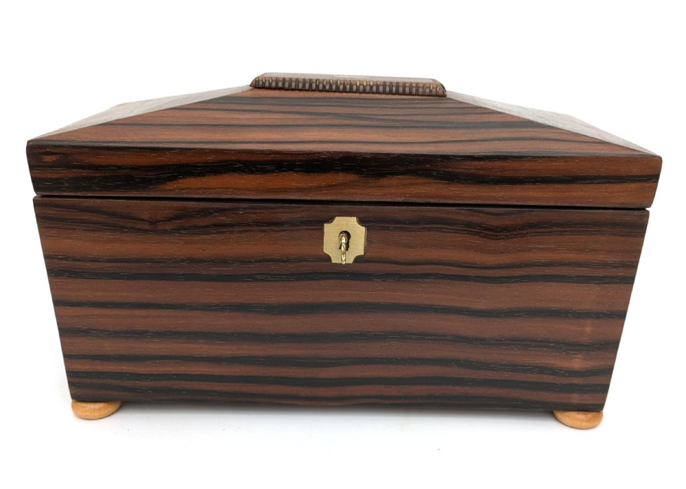 An open Art Deco dark wood tea caddy featuring a light wood sunburst inlay pattern on its internal lid. View IX