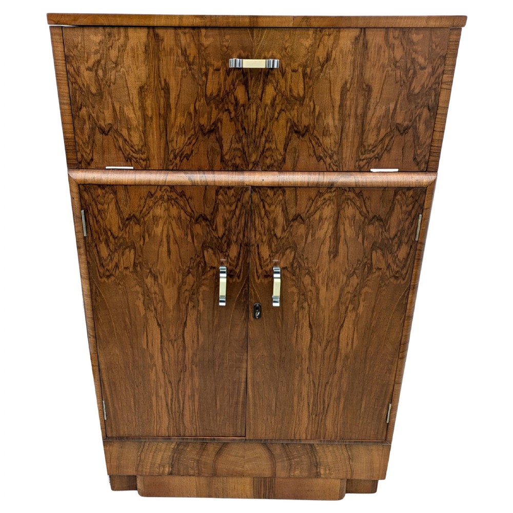 An Art Deco walnut cocktail cabinet featuring an upper pop-up section with integrated bar accessories and a mirrored drop-front serving shelf above double cupboard doors. View II