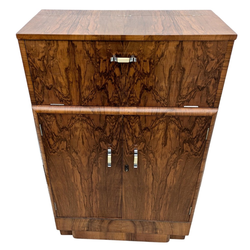 An Art Deco walnut cocktail cabinet featuring an upper pop-up section with integrated bar accessories and a mirrored drop-front serving shelf above double cupboard doors. View III