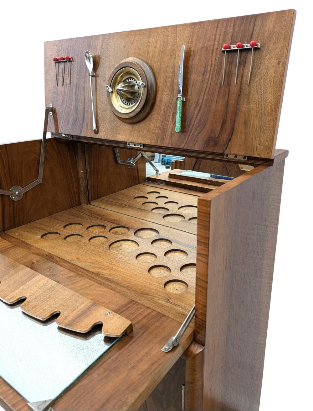 An Art Deco walnut cocktail cabinet featuring an upper pop-up section with integrated bar accessories and a mirrored drop-front serving shelf above double cupboard doors. View XIII