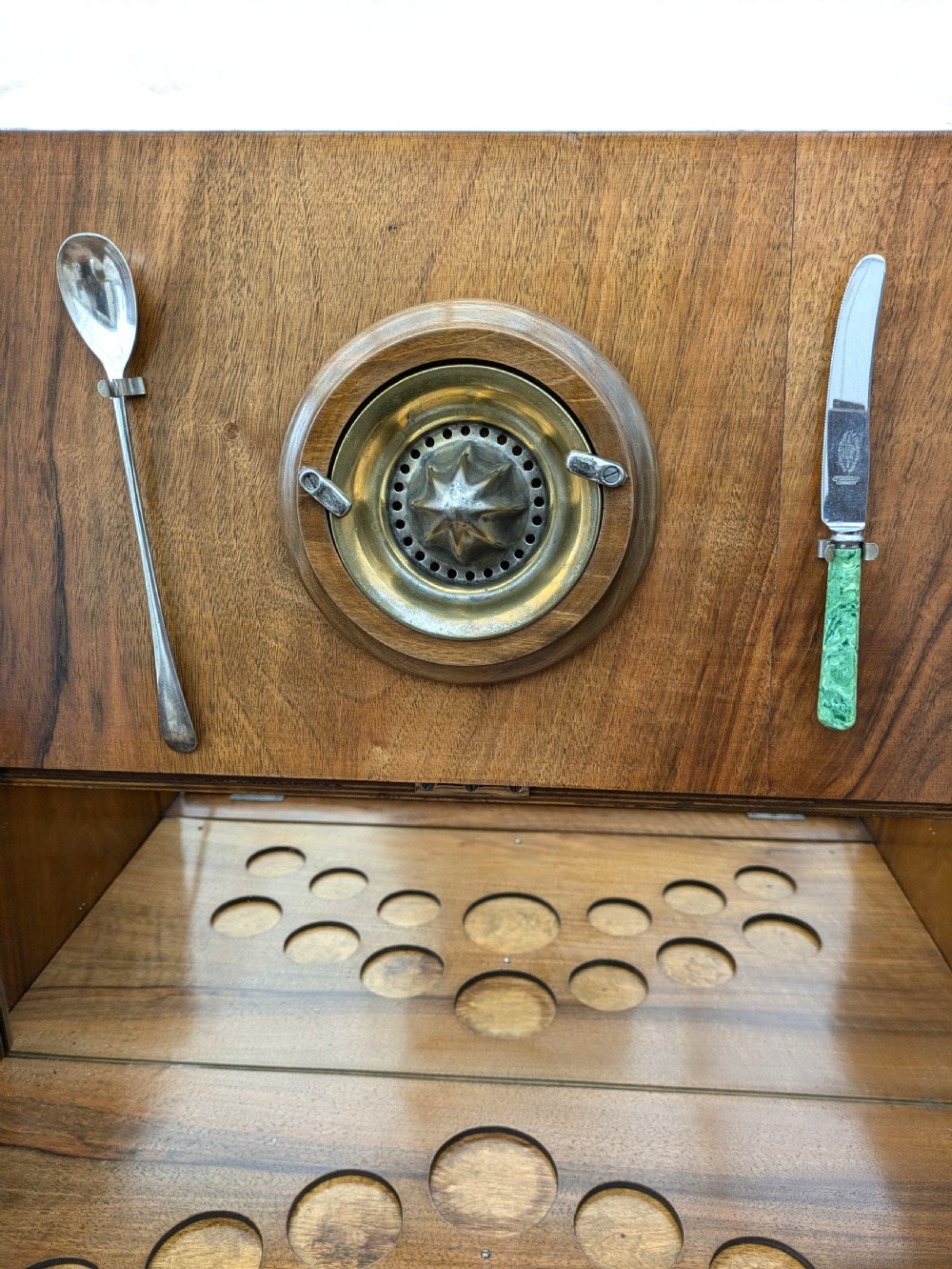 An Art Deco walnut cocktail cabinet featuring an upper pop-up section with integrated bar accessories and a mirrored drop-front serving shelf above double cupboard doors. View XV