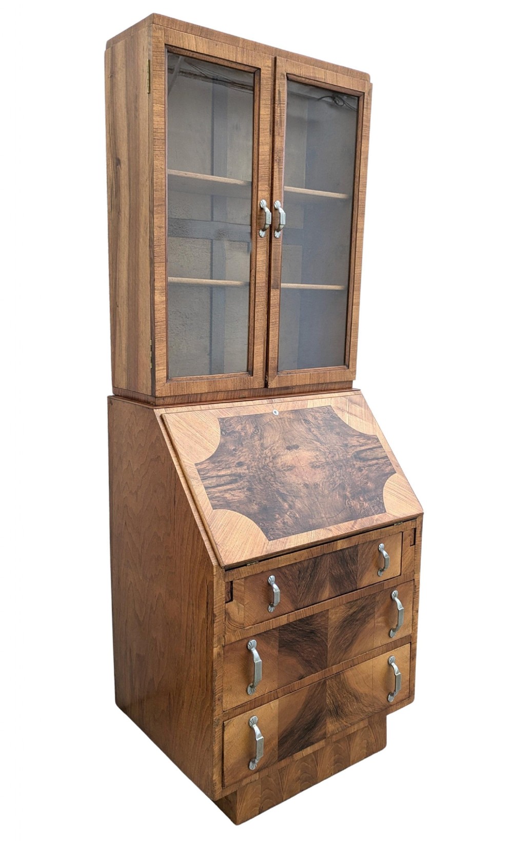 An Art Deco walnut upright bureau bookcase featuring a two-door glazed upper display cabinet above a slope-front writing slope and three drawers. View II