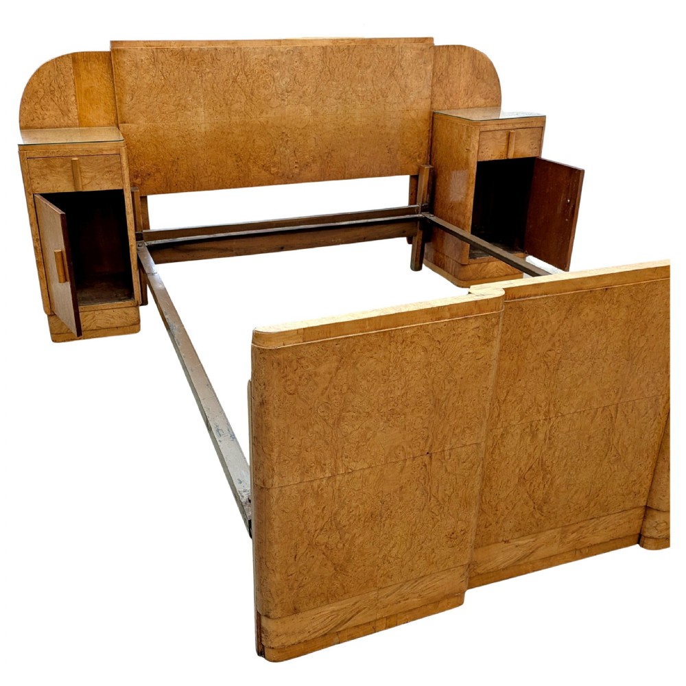 A 1930s Art Deco double bedstead crafted from blonde maple veneer featuring an arched headboard with integrated bedside cabinets and a matching stepped footboard. View IX