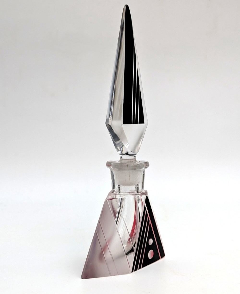 An Art Deco clear and frosted glass perfume bottle featuring a tall faceted stopper and black enamelled geometric designs. View III