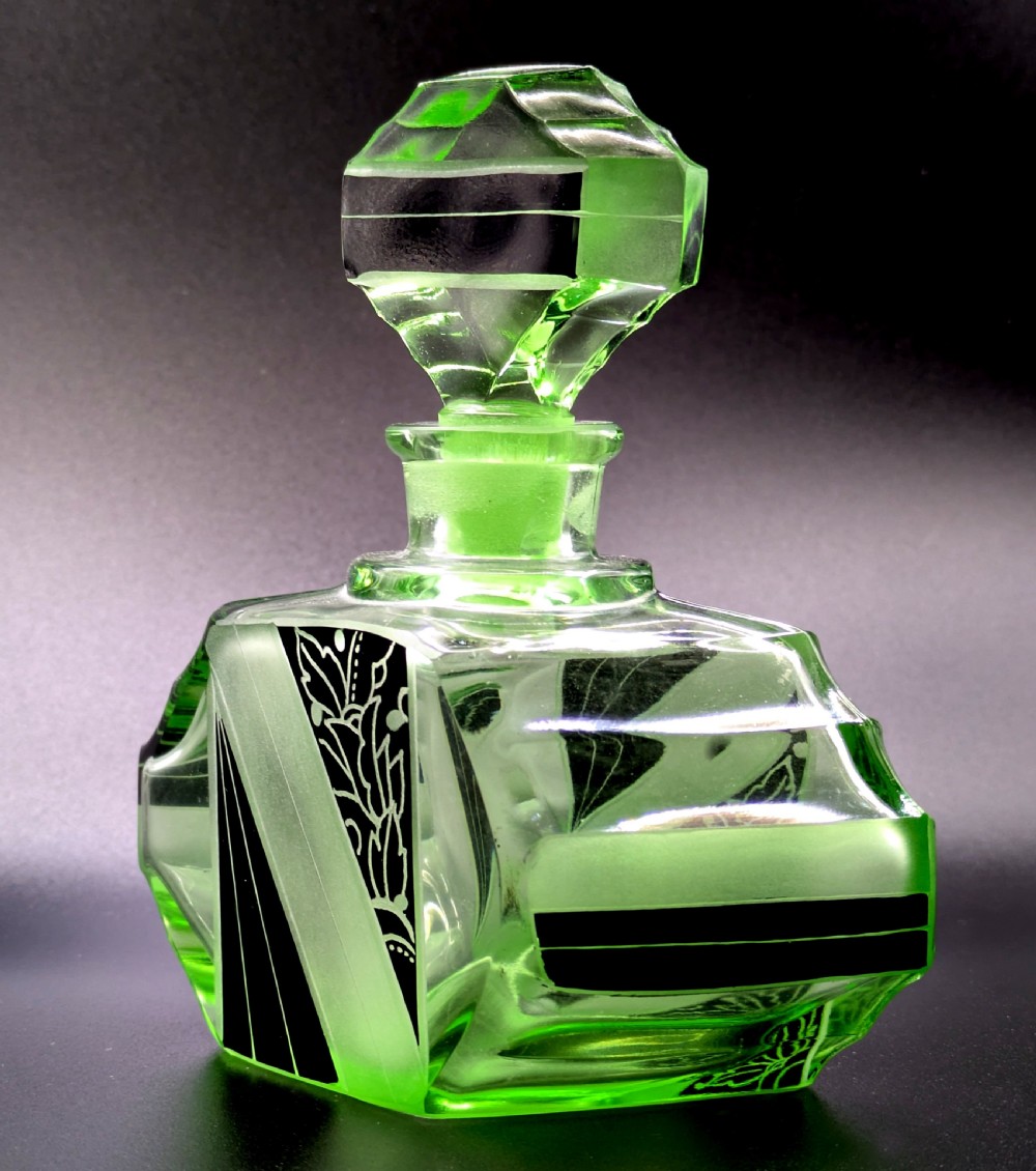 An Art Deco green glass perfume bottle featuring geometric black enamel and frosted foliage patterns with a faceted glass stopper. View XI