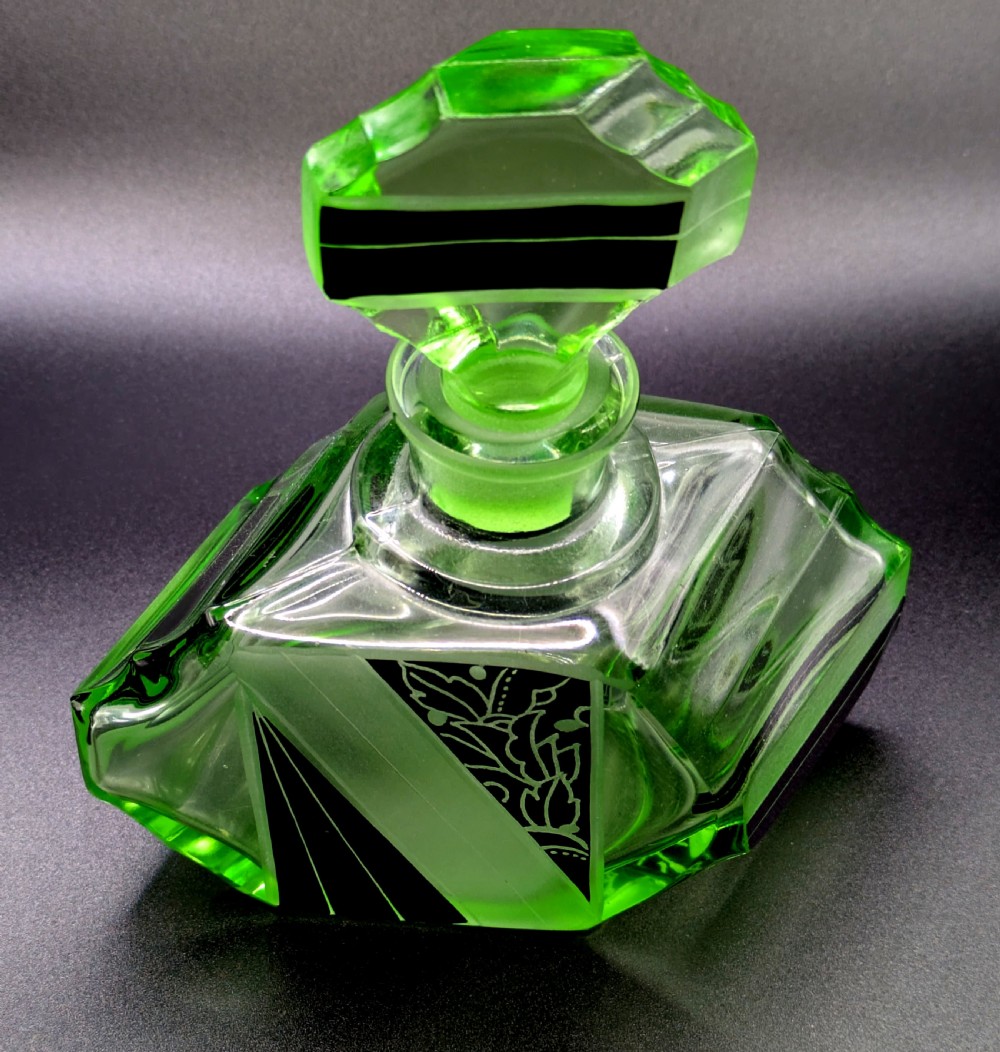 An Art Deco green glass perfume bottle featuring geometric black enamel and frosted foliage patterns with a faceted glass stopper. View XII