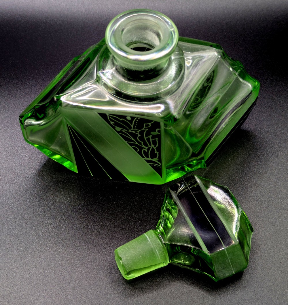 An Art Deco green glass perfume bottle featuring geometric black enamel and frosted foliage patterns with a faceted glass stopper. View XIII