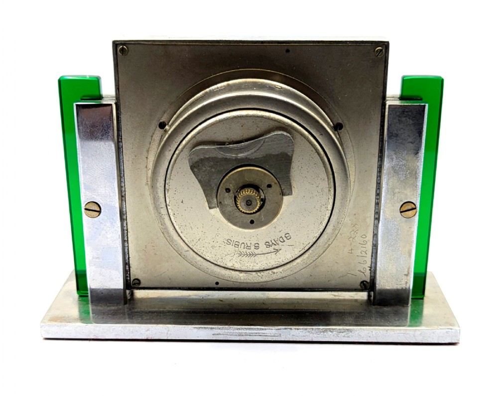 An Art Deco chrome-plated rectangular desk clock featuring green glass side accents and a square dial with geometric numerals. View IV