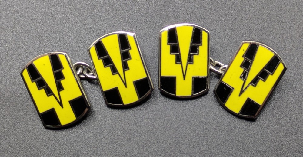 A pair of double-ended Art Deco cufflinks featuring geometric yellow and black enamel designs on silver metal mountings. View IV