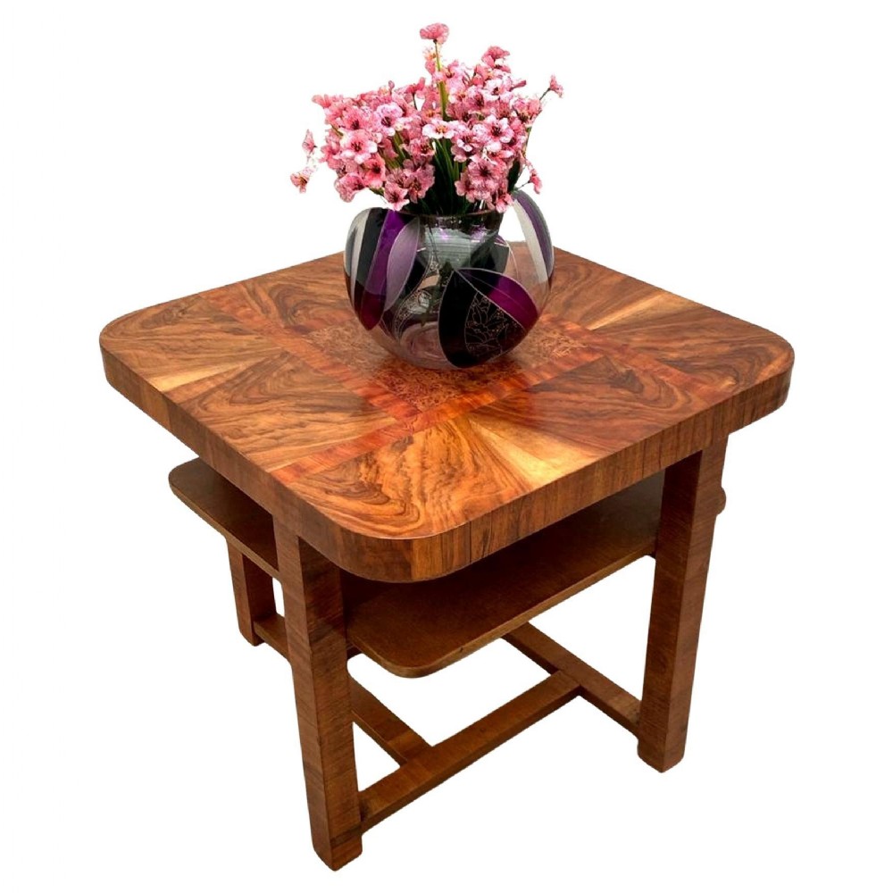An Art Deco square occasional table made of highly figured warm brown walnut veneer with two tiers and rounded corners.