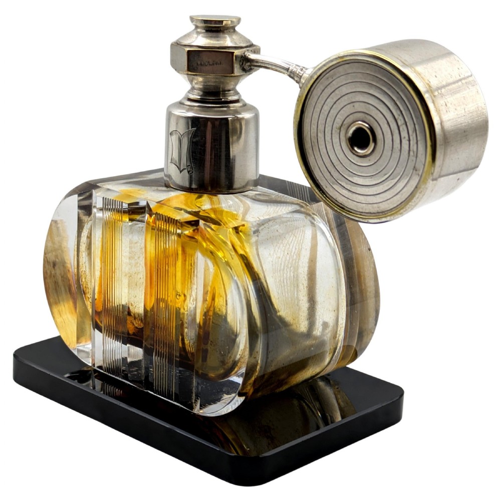 A French Art Deco cut glass perfume atomiser featuring a silver-toned metal spray mechanism mounted on a flat black rectangular base. View IV