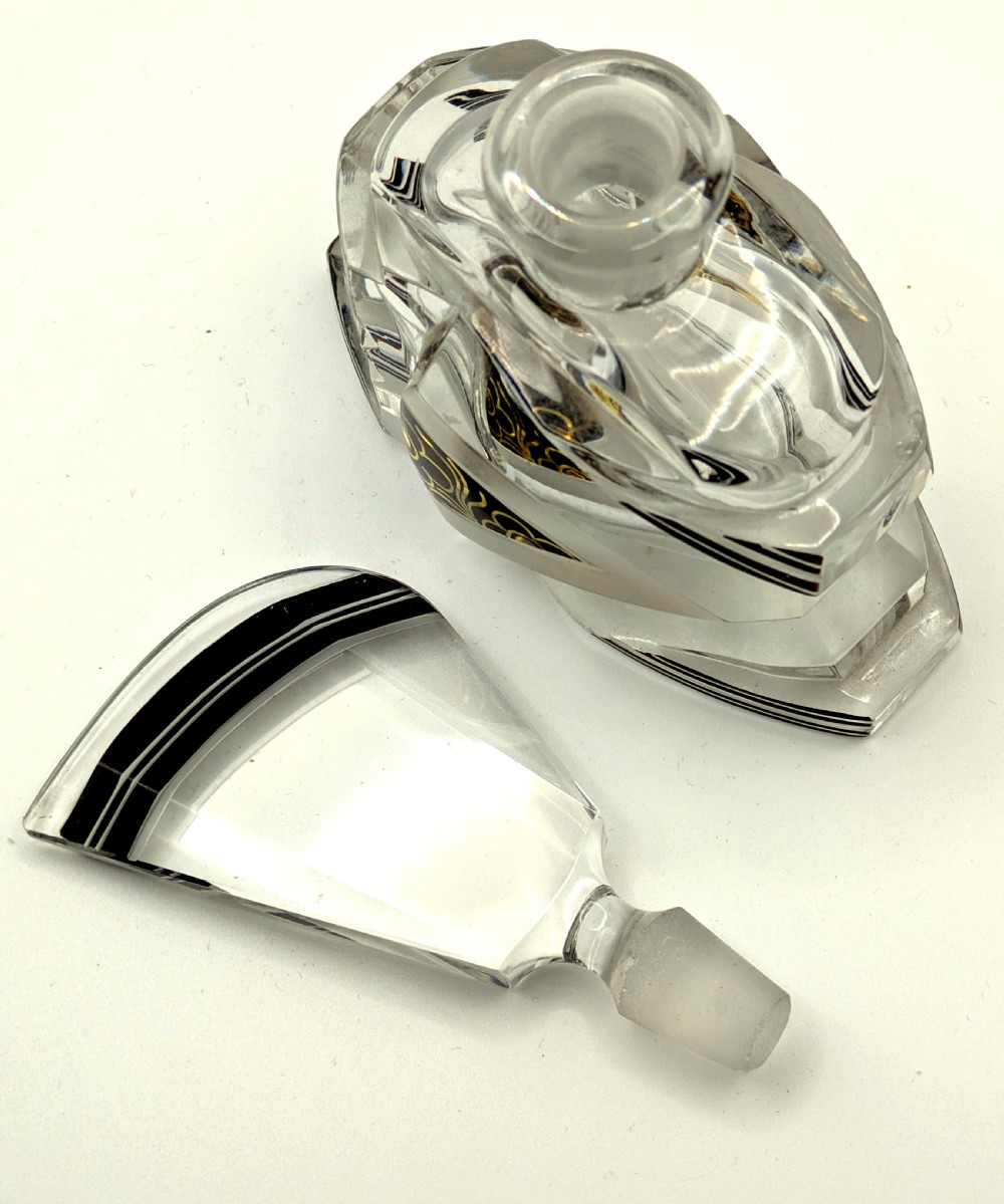 Geometric Art Deco clear glass perfume bottle with black enamel stripes, gold detailing, and a fan-shaped glass stopper. View V