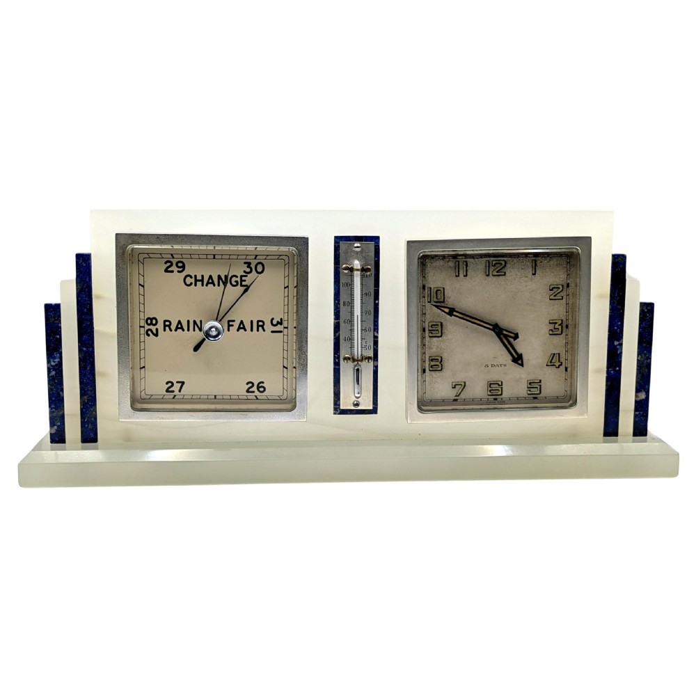 An Art Deco cream onyx desk weather station featuring a square barometer dial, central thermometer, and square clock face flanked by stepped blue lapis lazuli accents.