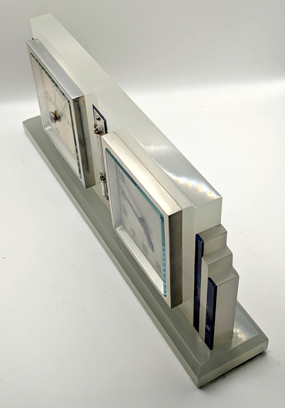 An Art Deco cream onyx desk weather station featuring a square barometer dial, central thermometer, and square clock face flanked by stepped blue lapis lazuli accents. View III