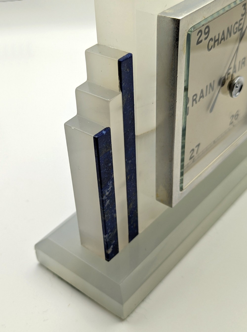 An Art Deco cream onyx desk weather station featuring a square barometer dial, central thermometer, and square clock face flanked by stepped blue lapis lazuli accents. View VI