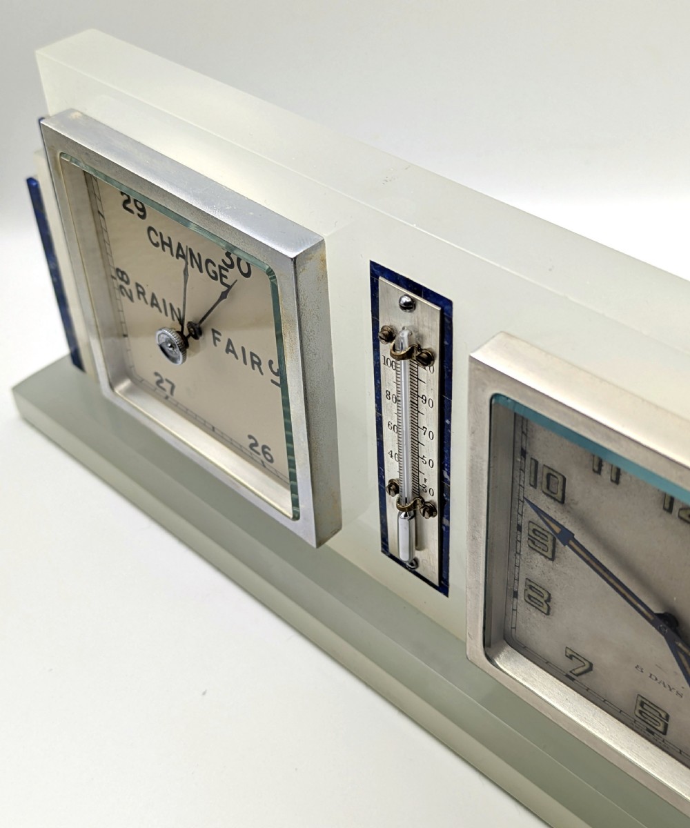 An Art Deco cream onyx desk weather station featuring a square barometer dial, central thermometer, and square clock face flanked by stepped blue lapis lazuli accents. View XI