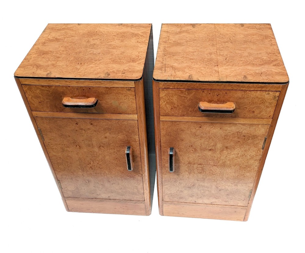 A pair of Art Deco blonde maple bedside cabinets, each featuring a single top drawer and a lower cupboard door with dark wooden handles. View II