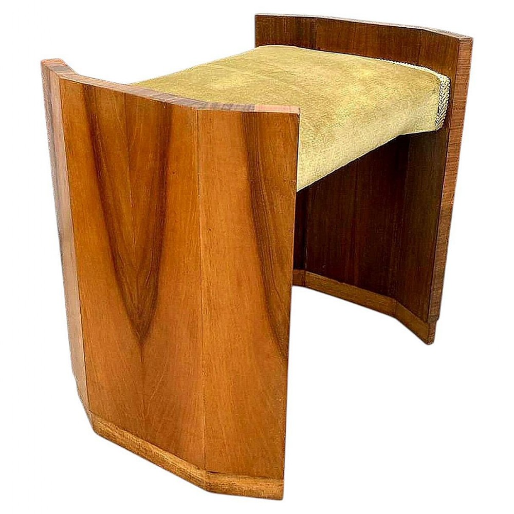 An Art Deco dressing table stool featuring curved figured walnut side supports and a padded velvet seat cushion.