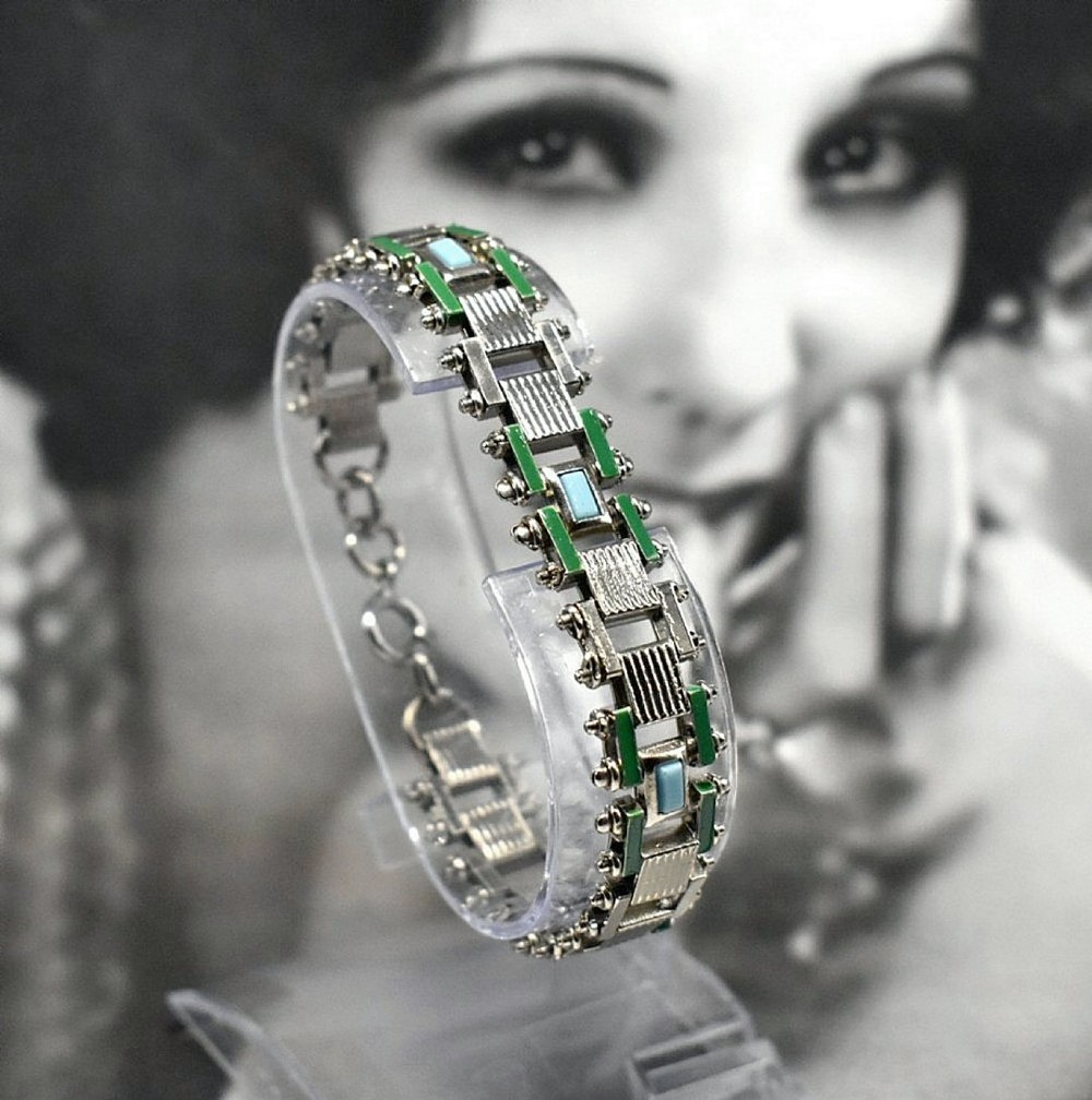 An Art Deco chrome-plated link bracelet featuring green and light blue geometric enamel detailing.