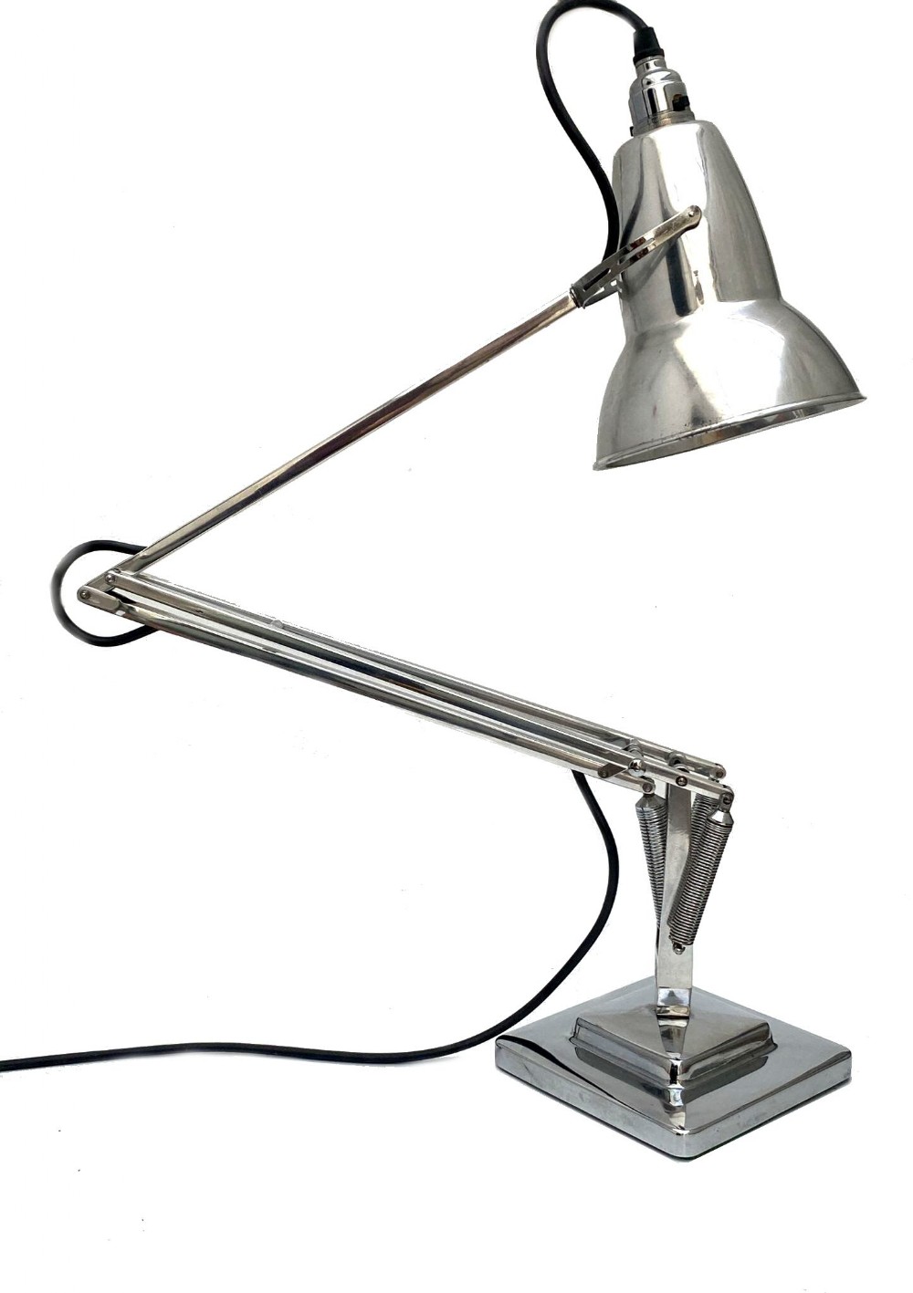 An Art Deco chrome-plated Herbert Terry Anglepoise desk lamp featuring an adjustable spring-articulated arm, a flared metallic shade, and a square tiered base.
