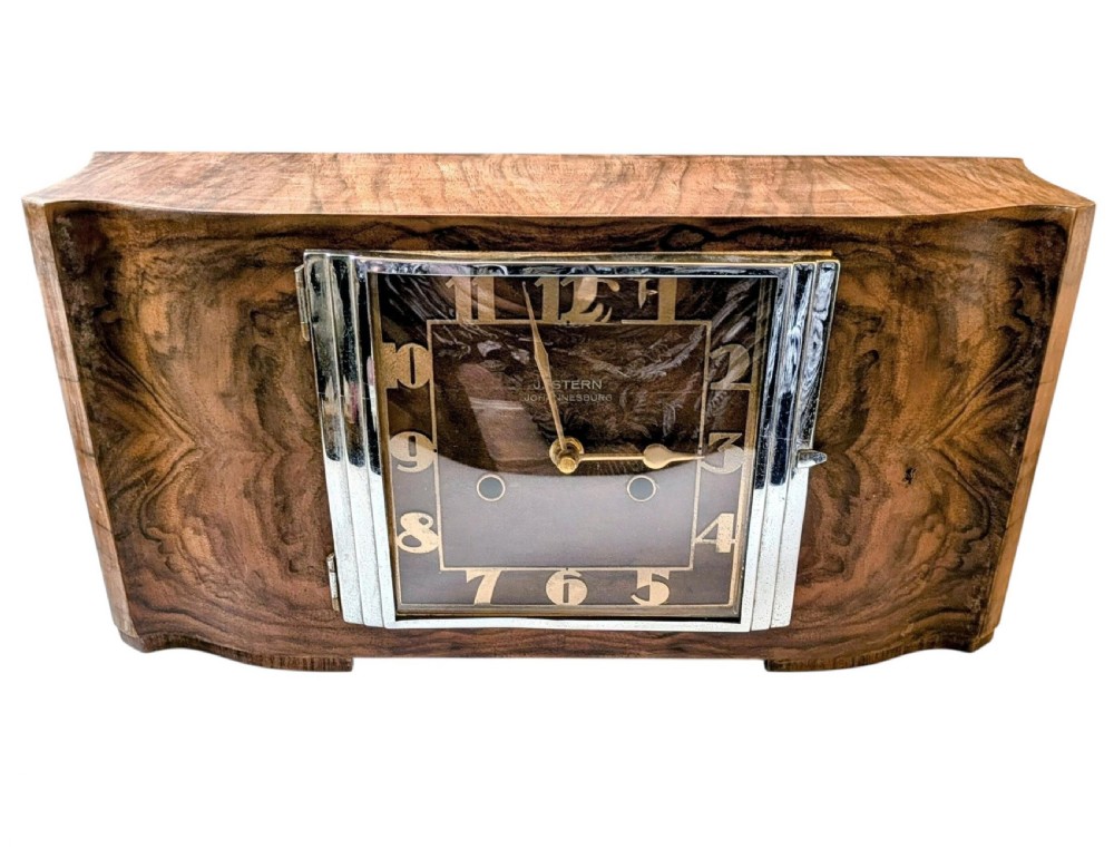 An Art Deco horizontal mantel clock crafted from figured walnut veneer featuring a square glass dial set within a polished chrome frame. View XIV
