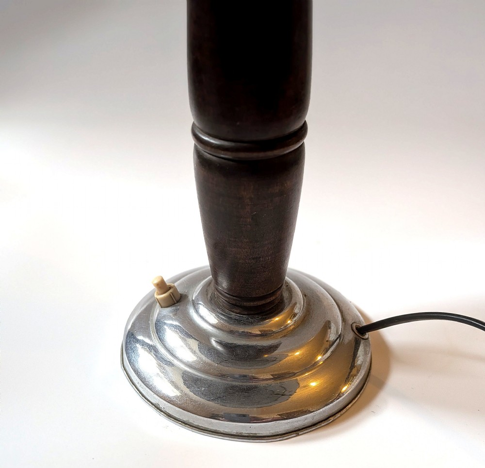 A 1930s Machine Age chrome desk lamp with a tiered metallic shade and a dark turned wood stem on a stepped circular base. View II