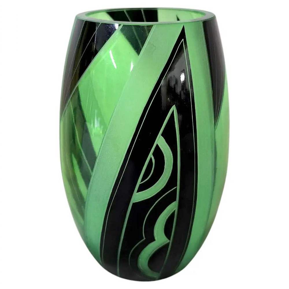 A barrel-shaped green uranium glass vase featuring geometric black enamelled and frosted panels in an Art Deco design.