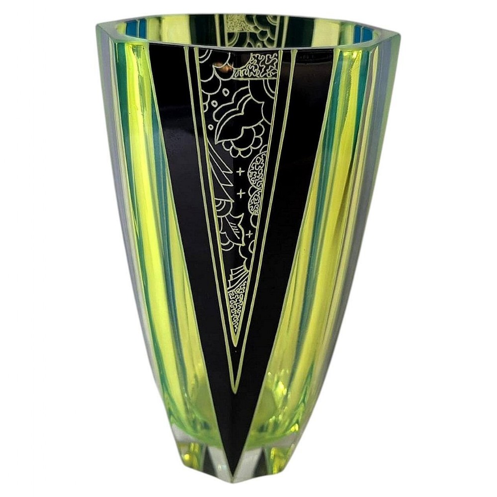 An Art Deco geometric uranium glass vase featuring black enamel triangular accents and etched abstract patterns.