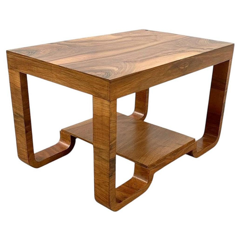 An Art Deco rectangular walnut occasional table featuring a two-tier design with curved, looping outer legs.