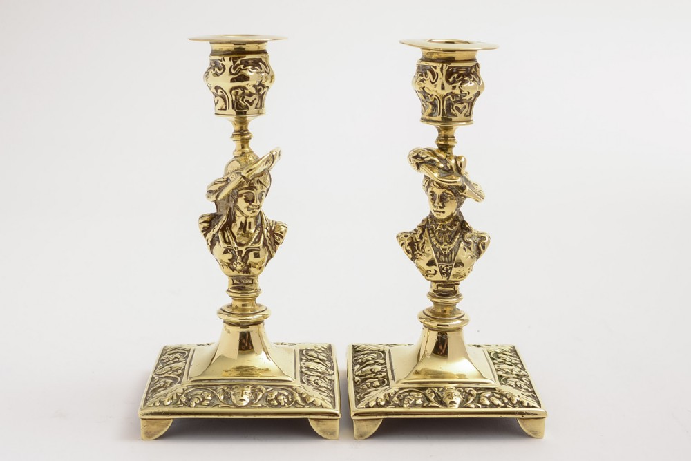 A stunning pair of Tudor Bust brass candlesticks
