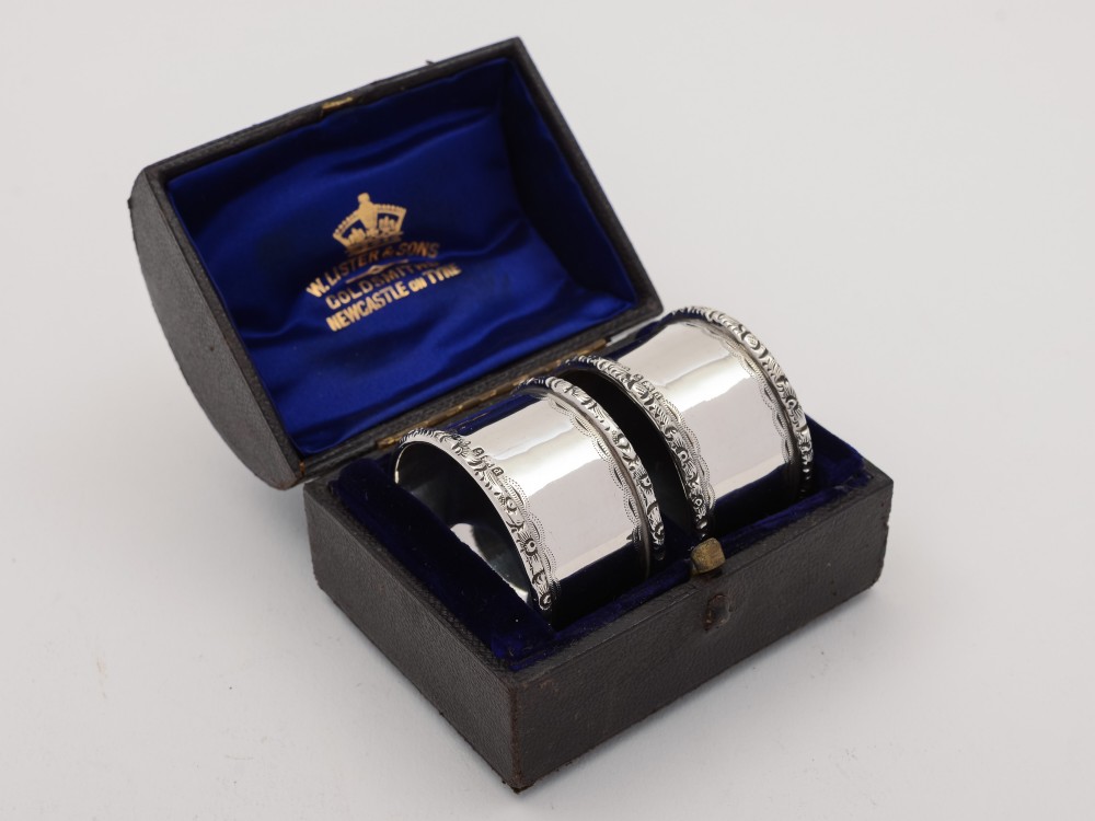 A pair of Edwardian silver napkin rings