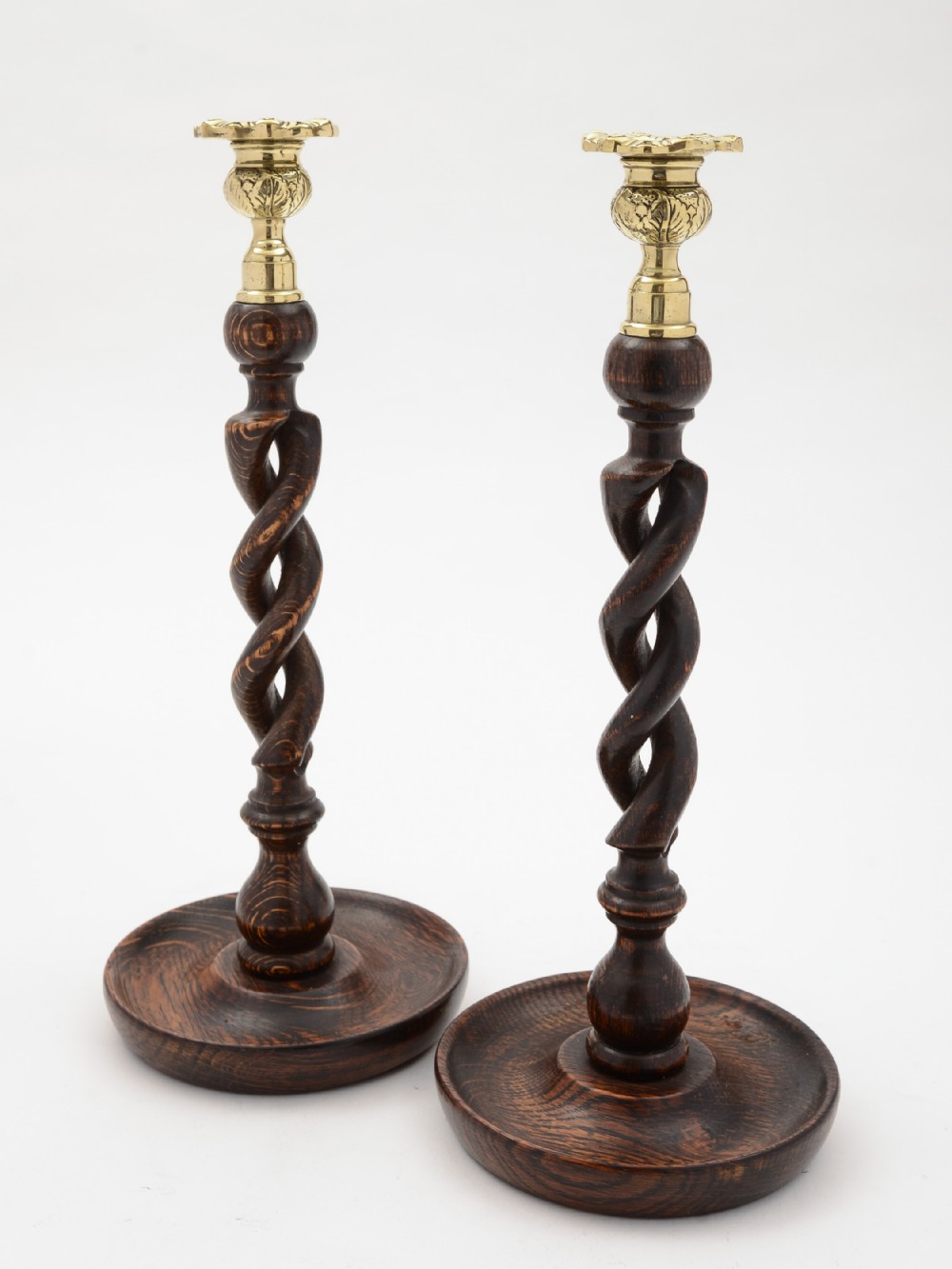 Pair of English Edwardian oak, open barley twist candlesticks