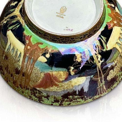 fig 1. A circular Wedgwood Fairyland Lustre porcelain bowl decorated with vibrant iridescent woodland scenes and fine gold leaf detailing.